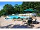 Relaxing pool area with ample seating and shade umbrellas, perfect for leisure at 356 Savannah Dr., Pawleys Island, SC 29585