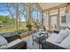 Relaxing sunroom featuring wicker furniture and tranquil views of the outdoor golf course at 356 Savannah Dr., Pawleys Island, SC 29585