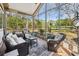 Bright sunroom with wicker furniture, brick flooring, and scenic backyard views at 356 Savannah Dr., Pawleys Island, SC 29585