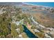 Serene aerial shot of a wooded lot near a lake, pool, and coastal scenery at 358 Salt Marsh Circle # 10-A, Pawleys Island, SC 29585