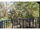 Balcony with chairs and a table and a view of surrounding trees at 358 Salt Marsh Circle # 10-A, Pawleys Island, SC 29585