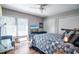 Comfortable bedroom featuring a ceiling fan, wood floors, and natural light from the windows at 358 Salt Marsh Circle # 10-A, Pawleys Island, SC 29585