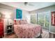 Bedroom with wood floors, ceiling fan, a large window, and bedside table at 358 Salt Marsh Circle # 10-A, Pawleys Island, SC 29585