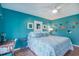Bright blue bedroom featuring wood floors, ceiling fan, and artwork at 358 Salt Marsh Circle # 10-A, Pawleys Island, SC 29585
