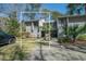 Charming townhome featuring a well-maintained lawn, mature trees, and ample parking space at 358 Salt Marsh Circle # 10-A, Pawleys Island, SC 29585