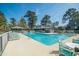 Inviting community pool with lounge chairs surrounded by mature trees and manicured lawns at 358 Salt Marsh Circle # 10-A, Pawleys Island, SC 29585