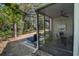 Screened-in porch features outdoor furniture and backyard views at 358 Salt Marsh Circle # 10-A, Pawleys Island, SC 29585