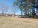 Spacious backyard featuring mature trees and storage sheds, offering privacy and functionality at 360 South Green Sea Rd., Loris, SC 29569