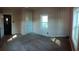 Bright bedroom featuring painted walls, carpet, and two windows, with a door leading to another room at 360 South Green Sea Rd., Loris, SC 29569