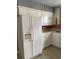 This kitchen boasts a spacious refrigerator, ample counter space, and white cabinets for storage at 3752 Tea Rose St. # 3752, Myrtle Beach, SC 29577