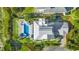 Aerial view of luxurious backyard with pool, palm trees, outdoor seating, and pristine landscaping at 3806 North Ocean Blvd., Myrtle Beach, SC 29577