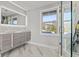 Elegant bathroom showcasing double sinks, marble countertop, and a glass door enclosed shower at 3806 North Ocean Blvd., Myrtle Beach, SC 29577