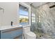Stylish bathroom featuring a walk-in shower with marble tiling and a modern vanity with blue cabinetry at 3806 North Ocean Blvd., Myrtle Beach, SC 29577