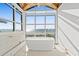 Bright bathroom with floor-to-ceiling window with ocean views, and a luxurious freestanding bathtub at 3806 North Ocean Blvd., Myrtle Beach, SC 29577
