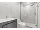 Contemporary bathroom featuring sleek fixtures, a glass-enclosed shower with a rain shower head and grey vanity at 3806 North Ocean Blvd., Myrtle Beach, SC 29577