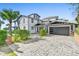 Charming home with a stone-paved driveway, black garage door, palm trees, and manicured landscaping at 3806 North Ocean Blvd., Myrtle Beach, SC 29577
