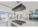 Open concept kitchen with a large island, stovetop, and views of the pool and ocean at 3806 North Ocean Blvd., Myrtle Beach, SC 29577