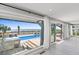 Bright living room featuring a sliding glass doors opening to a pool and a beachfront view at 3806 North Ocean Blvd., Myrtle Beach, SC 29577
