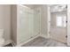 Bathroom featuring a glass walk-in shower adjacent to an open doorway leading into a bedroom at 395 S Crow Creek Dr. # 1708, Calabash, NC 28467