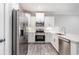 Bright kitchen with white cabinets, stainless steel appliances, and stylish backsplash at 395 S Crow Creek Dr. # 1708, Calabash, NC 28467