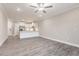 Open concept living room with kitchen view, features gray floors and a ceiling fan at 395 S Crow Creek Dr. # 1708, Calabash, NC 28467