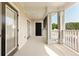 Outdoor porch featuring concrete flooring and a black front door at 395 S Crow Creek Dr. # 1708, Calabash, NC 28467