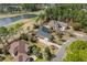 Aerial view showcases property nestled among lush greenery, adjacent to a picturesque golf course and lake at 4222 Congressional Dr., Myrtle Beach, SC 29579