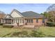 Backyard with brick patio and a cozy screened in porch for tranquil outdoor relaxation and leisure at 4222 Congressional Dr., Myrtle Beach, SC 29579