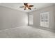 Carpeted bedroom featuring two windows, ceiling fan, and neutral colored walls at 4222 Congressional Dr., Myrtle Beach, SC 29579