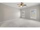 Large, carpeted bedroom with two shuttered windows and a ceiling fan at 4222 Congressional Dr., Myrtle Beach, SC 29579