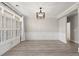 Elegant dining room with wood floors, decorative molding, modern light fixture, and large windows at 4222 Congressional Dr., Myrtle Beach, SC 29579