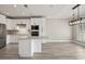 Bright kitchen featuring white cabinets, stainless appliances, a center island, and modern light fixture at 4222 Congressional Dr., Myrtle Beach, SC 29579