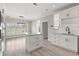 Bright kitchen featuring white cabinets, a center island, stainless steel appliances, and wood flooring at 4222 Congressional Dr., Myrtle Beach, SC 29579