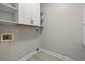 Convenient laundry area features storage cabinets, shelving, and utility connections for seamless chore management at 4222 Congressional Dr., Myrtle Beach, SC 29579