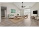 Bright living room with vaulted ceiling, wood floors, comfortable furniture, and french doors to the outside at 4222 Congressional Dr., Myrtle Beach, SC 29579