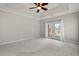Bright main bedroom featuring access to outdoor patio and a ceiling fan at 4222 Congressional Dr., Myrtle Beach, SC 29579