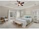 Bright main bedroom with tray ceiling, ceiling fan, and access to outdoor patio at 4222 Congressional Dr., Myrtle Beach, SC 29579
