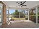 Relaxing screened-in porch with a ceiling fan, providing a comfortable space for outdoor enjoyment at 4222 Congressional Dr., Myrtle Beach, SC 29579