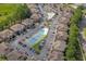 Aerial view showcases a community with swimming pools, tennis courts, and lush landscaping at 4234 Pinehurst Circle # L1, Little River, SC 29566