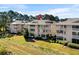 An inviting condo complex nestled among trees and greenery, a serene residential escape at 4234 Pinehurst Circle # L1, Little River, SC 29566