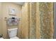 The bathroom features a toilet and a shower with a yellow patterned shower curtain at 4234 Pinehurst Circle # L1, Little River, SC 29566