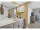 This stylish bathroom offers a marble top vanity, white cabinets, and modern lighting at 4234 Pinehurst Circle # L1, Little River, SC 29566