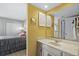 This bathroom features a vanity with a large mirror adjacent to a bedroom at 4234 Pinehurst Circle # L1, Little River, SC 29566