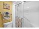 This bathroom is equipped with a toilet, and a glass shower with towel racks and safety bar at 4234 Pinehurst Circle # L1, Little River, SC 29566