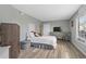 This bright bedroom features wood-look flooring, light gray walls, and a soft white quilt at 4234 Pinehurst Circle # L1, Little River, SC 29566