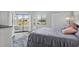The bedroom features an exterior door, white furnishings and a comfortable bed with blue bedding at 4234 Pinehurst Circle # L1, Little River, SC 29566