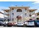 Inviting condo exterior with covered balconies, neutral tones, and ample parking, offering a glimpse of comfortable living at 4234 Pinehurst Circle # L1, Little River, SC 29566