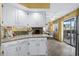 Bright kitchen with granite counters, white cabinets, open to dining room, and stainless steel appliances at 4234 Pinehurst Circle # L1, Little River, SC 29566