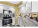 A bright kitchen with stainless steel appliances, granite countertops, and white cabinets at 4234 Pinehurst Circle # L1, Little River, SC 29566