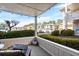 Covered patio with outdoor furniture overlooking lush greenery and a glimpse of the community at 4234 Pinehurst Circle # L1, Little River, SC 29566